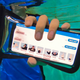 A diver demonstrating the AquaApp on a smartphone protected in a waterproof case.